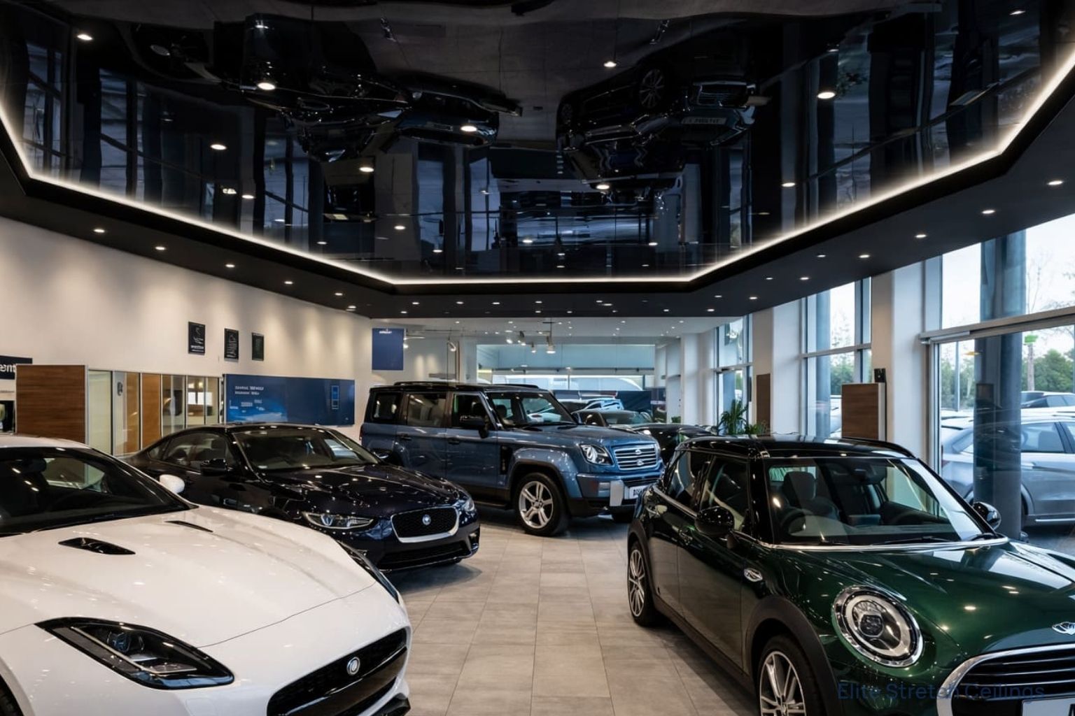 Commercial gloss stretch ceiling installation for a car showroom.